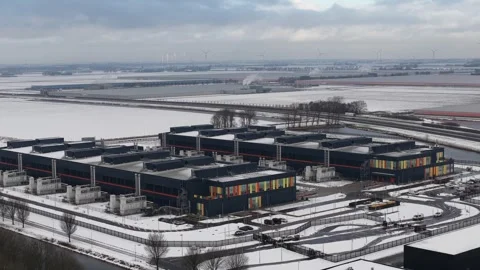 Aerial view of data center with wind turbines in winter landscape Stock Footage 328075292