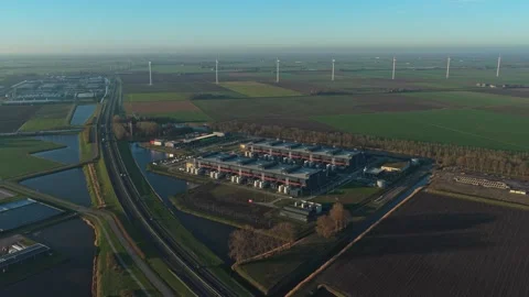 Aerial view of data center with wind turbines at sunrise Stock Footage 331201390