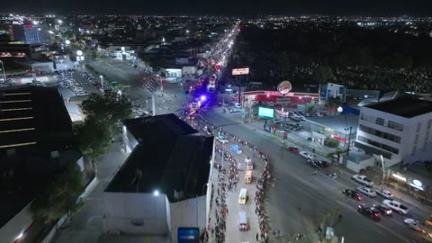 Aerial View of Day of the Dead Parade Through City Streets at Night. Stock Footage 337906373
