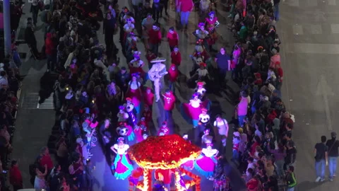 Aerial View of Day of the Dead Parade with Illuminated Float and Costumed. Stock Footage 337917262