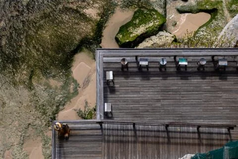 Aerial view of a decked seating area on a beach with a the sea coming in Stock Photos