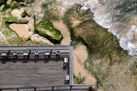 Aerial view of a decked seating area on a beach with a the sea coming in Foto stock