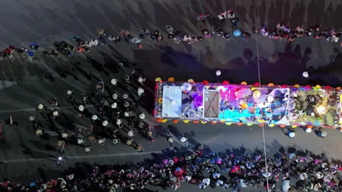 Aerial View of Decorated Parade Float with Musicians and Crowd at Night. Stock Footage 337909316