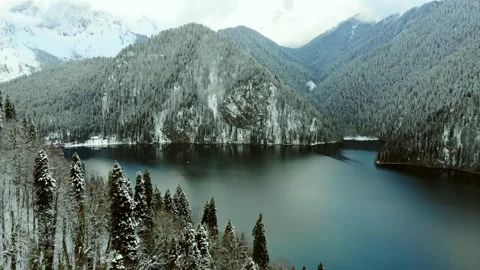 Aerial view of deep alpine lake with blue water, surrounded by mountains. Stock Footage 152201450