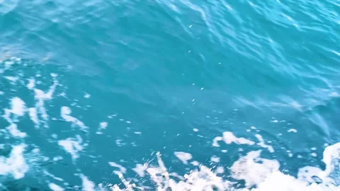 Aerial view of deep blue ocean surface with white foam waves Stock Footage 340533309