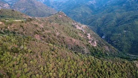 Aerial view of deep mountain gorge, dense forest and rugged slopes in Greece Stock Footage 321588046