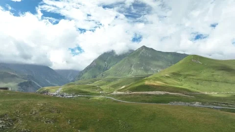 Aerial view of a deep mountain gorge with a winding riverbed 動画素材 323345935