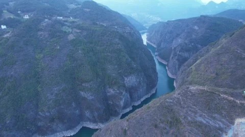Aerial view of deep river canyon with steep cliffs and lush green forest Video stock 342231507