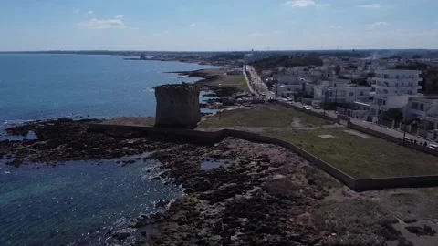 Aerial view of a defense tower in a stretch of coast eroded by the sea Stock Footage 194033486