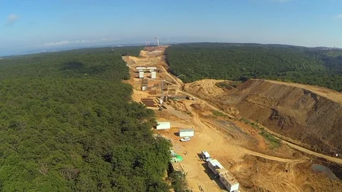 Aerial View of Deforestation for Building a Bridge and Road Stock Footage 100370440