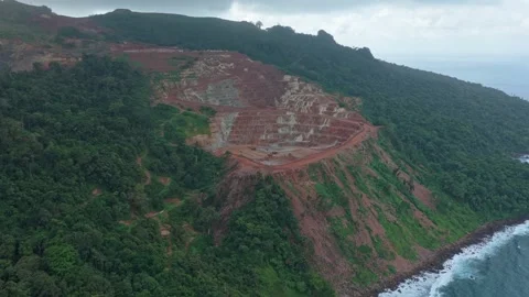Aerial view of deforestation for open pit mining on tropical coastline Stock Footage 328920658