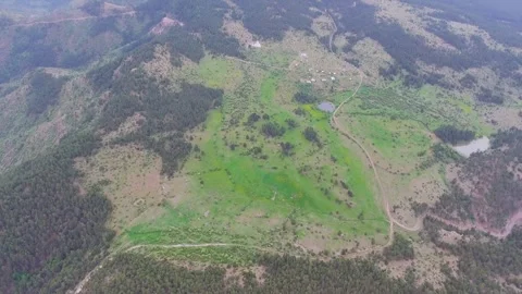 Aerial view of deforestation scars across dense forest and meadow clearing Stockbeeldmateriaal 339466582