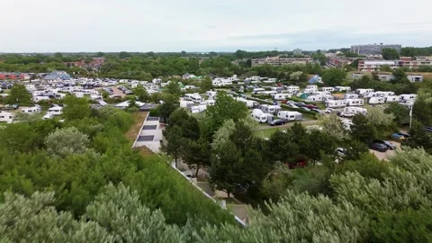 Aerial view of dense campground with rows of caravans, motorhomes, roads Stock-Footage 318030884