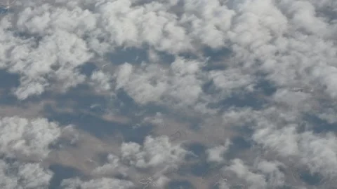 Aerial view of dense cloud cover floating above land from high altitude 스톡 동영상 311107433