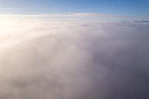 Aerial view of a dense cloud layer under a blue sky Stock Photos