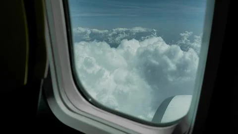 Aerial View of Dense Cumulus Clouds from Airplane Window Seat 스톡 사진