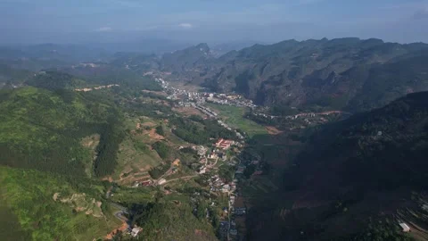 Aerial view of a dense green mountain range with abundant trees Ha Giang Loop Stock Footage 277592606