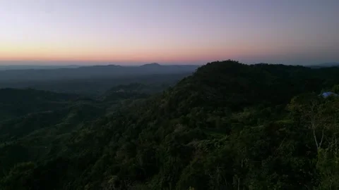 Aerial view of dense green mountain range at sunset or sunrise twilight, dr.. Vídeo Stock 345089094