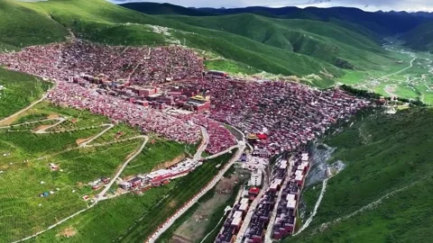 Aerial View of a Dense Red Tiled Town Nestled in Green Mountains Garze Sichuan Stock-Footage 346986183
