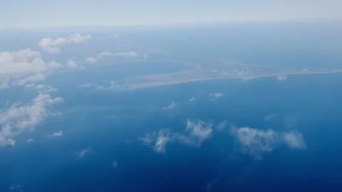 Aerial view dense white clouds over deep blue ocean subtle wave patterns Stock Footage 310196353