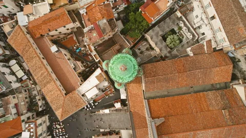 Aerial view of a densely built section of Amalfi with the prominent green dome Stock Footage 277005366