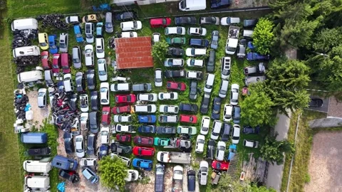 Aerial view of a densely packed auto salvage yard with dismantled car bodies Stock Footage 339583306