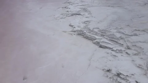 Aerial view of deposits of thick layer of salt on beaches of salt lake with pink Stock Footage 195931709