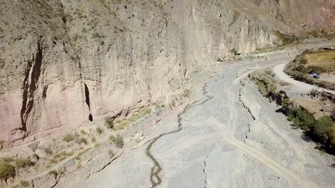 Aerial view of desert cliff with dry riverbed during sunny day Stock Footage