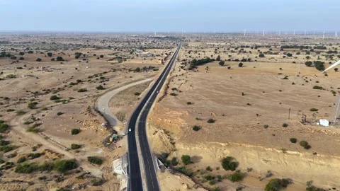 Aerial View of Desert Highway with Wind Turbines in Jaisalmer Stock Footage 332886463
