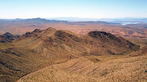Aerial view of desert mountain range and lake 4k Stock Footage 81040705