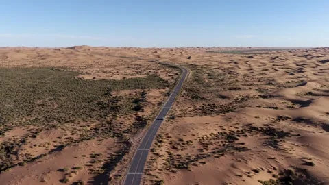 Aerial view of desert road through Tengger Desert dunes Stock Footage 345370295