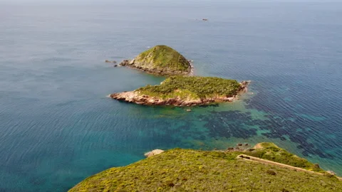 Aerial view of a deserted island with dramatic green landscape Stock Footage 323023387