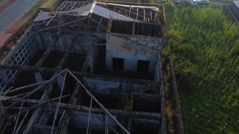 Aerial view of a devastated building with a missing rooftop Stock Footage 320159347