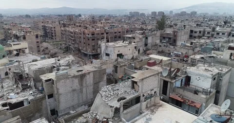 Aerial view of devastated neighborhoods at Yarmouk Camp, Damascus, Syria Stock Footage 254375643