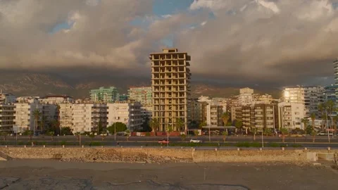 Aerial View: A developing high-rise stands proudly on the first line, offering Stock Footage 296078887