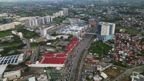 Aerial view of developing high-rise district and busy highway in Iloilo City Video stock 333285175