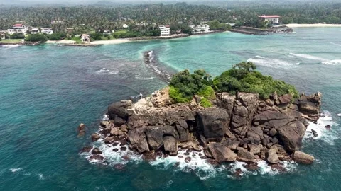Aerial view of Devil's Rock islet and turquoise ocean, Sri Lanka. Stock Footage 335906839