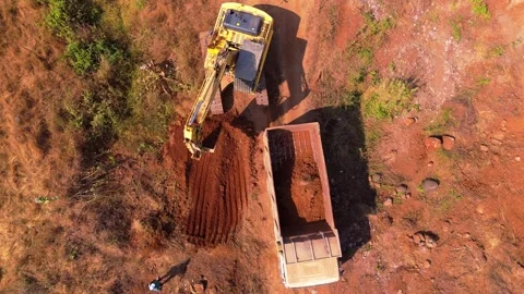 Aerial view digger loading mud into lorry Stock Footage 297239297