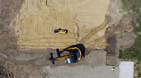 Aerial view of a digger  tracked excavators at work on a construction site Stock Footage 63974723