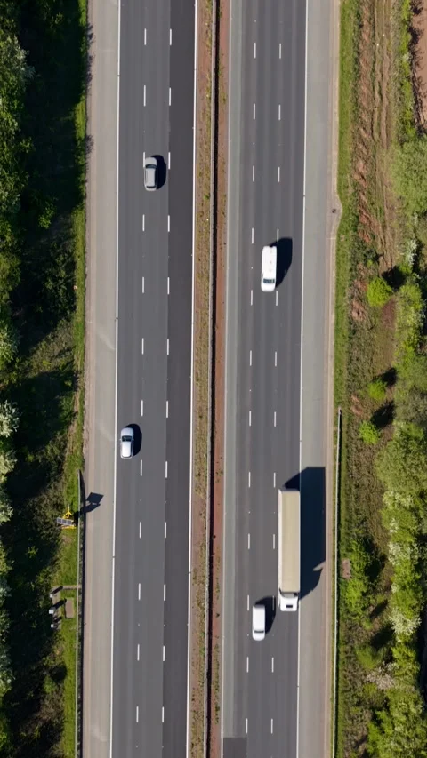 Aerial view directly above tracking speeding motorway traffic with motion Stock Footage 340168324
