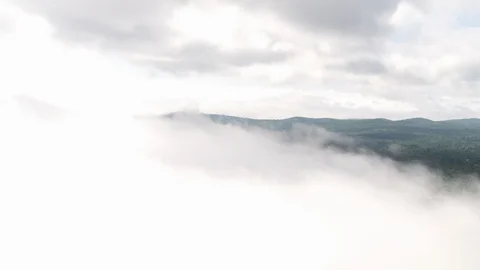 Aerial View of Distant Mountains through Clouds Stock Footage 95568062