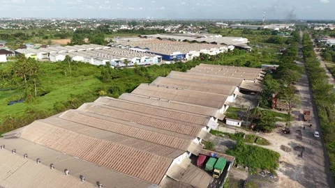 Aerial view of distribution warehouses of several companies lined up neatly.. Stock Footage 336473295