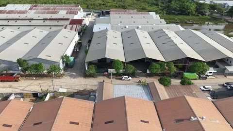 Aerial view of distribution warehouses of several companies lined up neatly.. Video stock 337014190