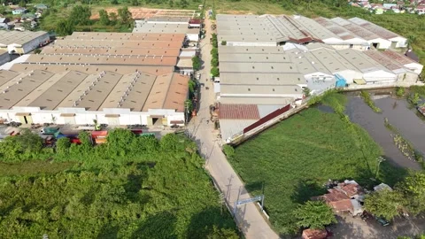 Aerial view of distribution warehouses of several companies lined up neatly.. 스톡 동영상 337014248