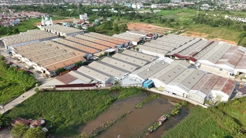 Aerial view of distribution warehouses of several companies lined up neatly.. Video stock 337014376
