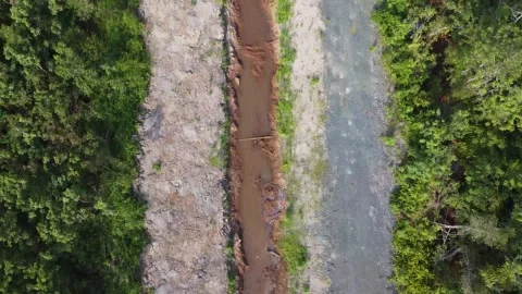 Aerial view of a ditch made to drain water over dry land Stock Footage 247942080
