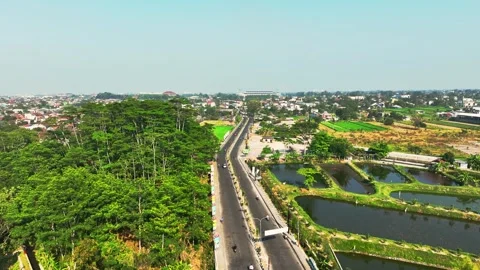 Aerial view of divided urban highway running through green Yogyakarta landsca Stock Footage 346741347