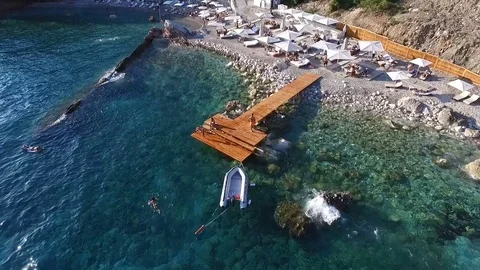 Aerial view dock with an inflatable boat near the beach Stock Footage 76635326