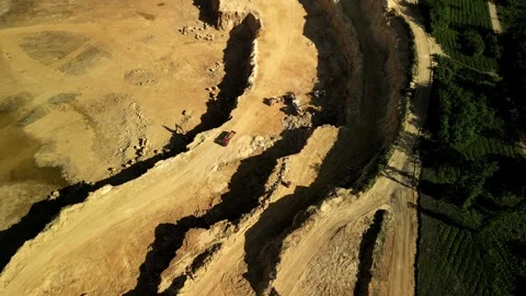 Aerial View of Dolomite Open-Pit Mine with Working Trucks and Excavators Next to Stock Footage 277357846