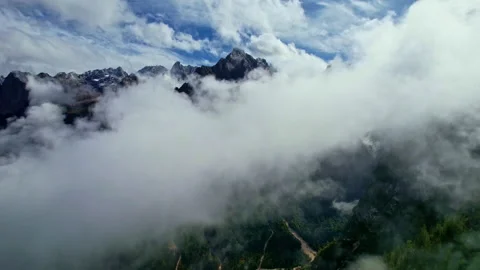Aerial view of the Dolomites through the clouds Stock Footage 220663487